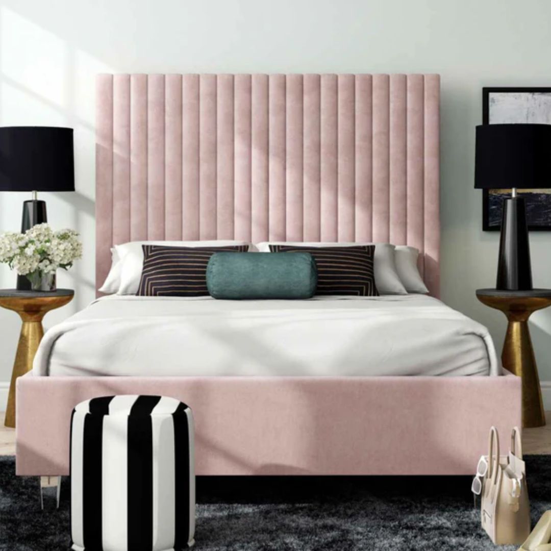 Bedroom with a pink upholstered headboard and matching footboard.