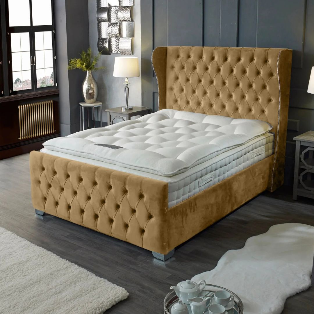 Beige upholstered bed with mattress in a bedroom setting