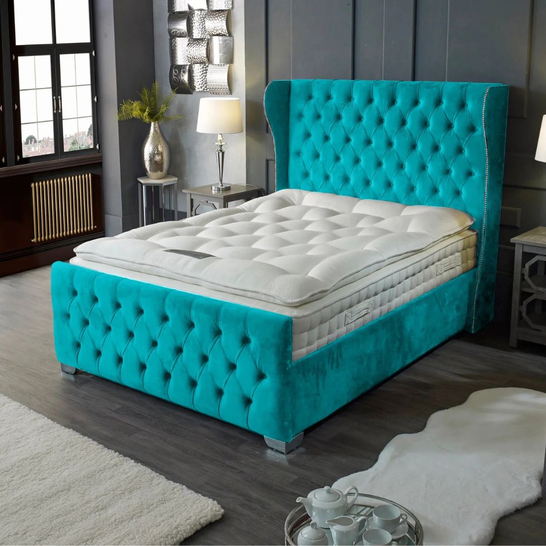 Turquoise bed with tufted design in a bedroom setting
